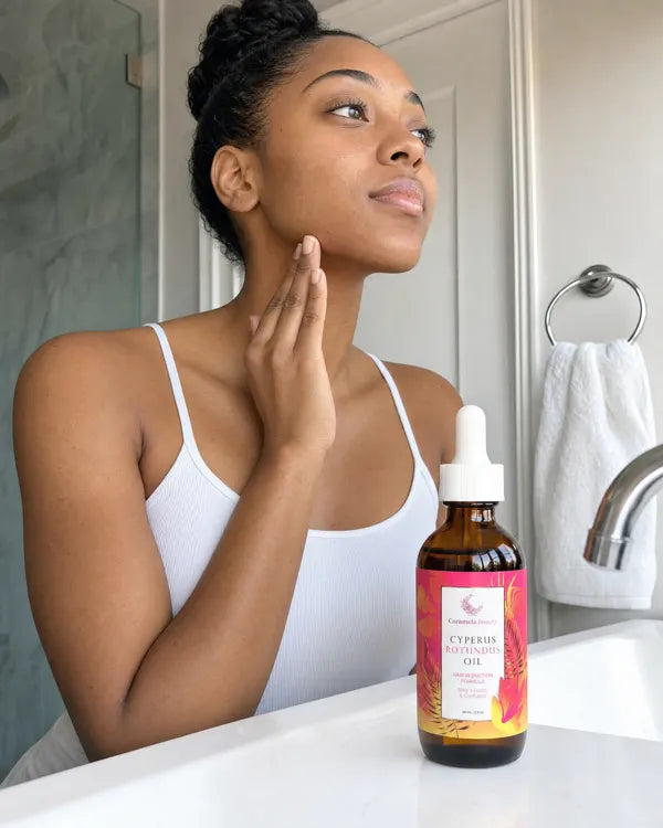 Woman smoothing Caramela oil along her jawline